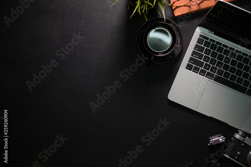 Black office workspace desk table with laptop, office supplies and copy space photo