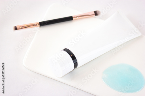 Cosmetics flat lay on white background