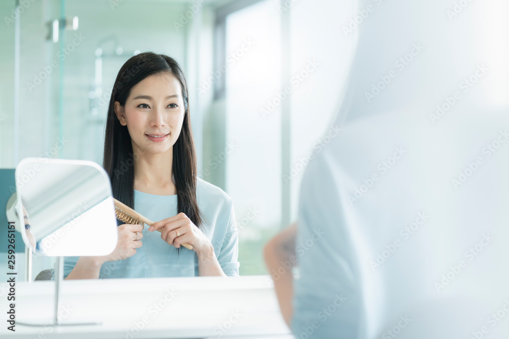 beautiful asian woman makeup and hair set wirh mirror in bathroom with morning light beautiful asian woman makeup and hair set wirh mirror in bathroom with morning light