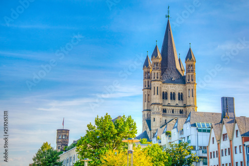 Colorful facades and spire of the Saint martin church in cologne, Germany photo