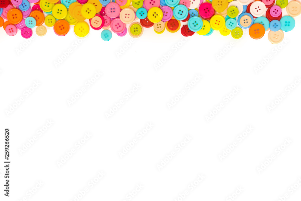 Colorful Sewing buttons on white background. Top view. Free space. Border