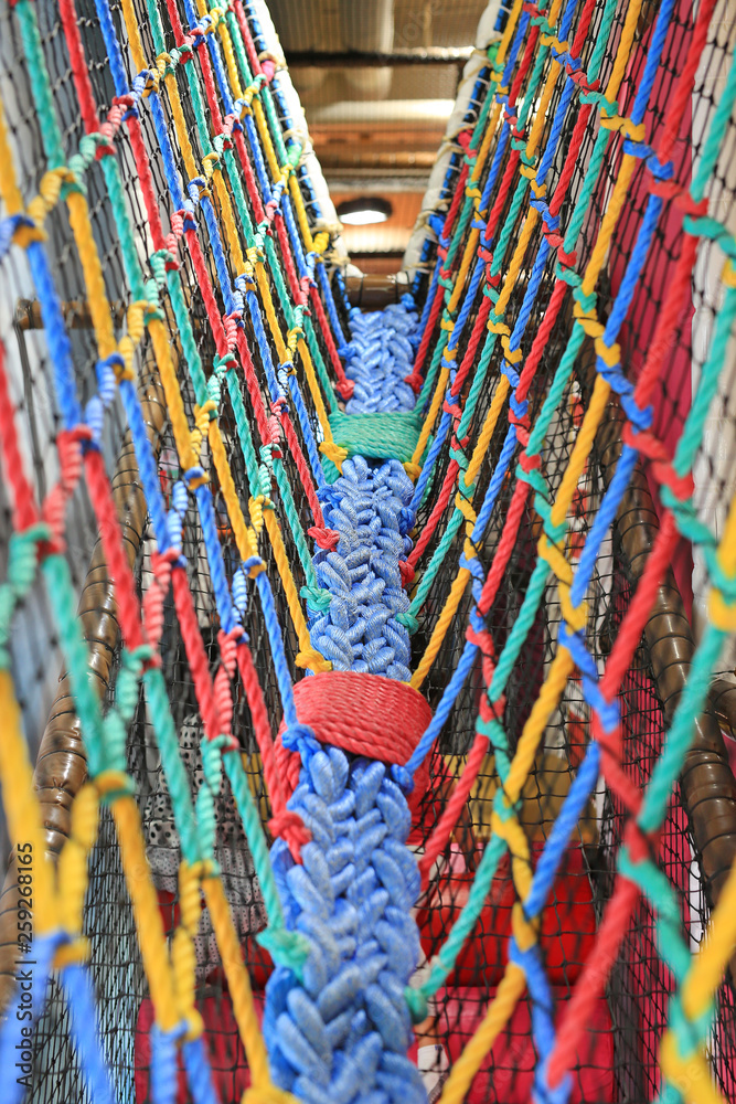 Colorful Walk bridge rope with side rope protection on indoor playground.