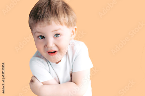 Portrait of little boy screaming with opened mouth and crazy expression. Surprised or shocked face