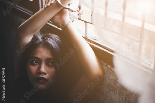 Woman has been detained by human traffickers at abondoned building by being handcuffed. Asian woman can not escape from building. Apparently, she is looking for someone who can assist her for escape.