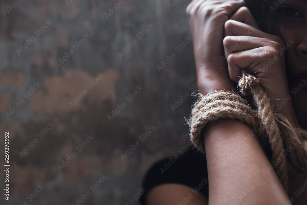 Asian woman trafficking, kidnap or abduct. Detainees was tied rope at arms. She get hopeless, depressed. Detainee was detain and hidden by human traffickers. She detain alone in dirty room copy space