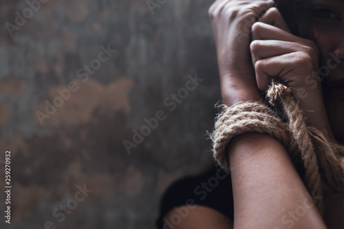 Asian woman trafficking, kidnap or abduct. Detainees was tied rope at arms. She get hopeless, depressed. Detainee was detain and hidden by human traffickers. She detain alone in dirty room copy space