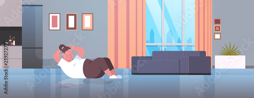 fat obese woman doing press abdominal exercises girl training workout weight loss concept modern apartment living room interior horizontal full length