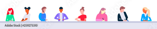 mix race students sitting in row at table desk doing exam task lecture hall studying process modern university classroom education learning concept portrait flat horizontal banner