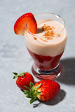 fresh strawberry yoghurt milkshake on table, vertical closeup