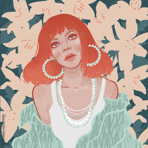 beautiful fashion girl with bright red hair in stylish jewelry on a background of blooming lilies