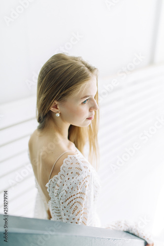 Wedding in the style of fine art. Beautiful bride in white interior Studio with stairs. Free Download Wedding in the style of fine art. Beautiful bride in white interior Studio with stairs. - GFXLoad
