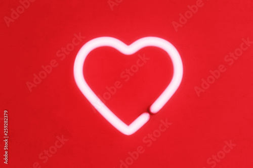 Glowing neon heart on a red background. 3d rendering
