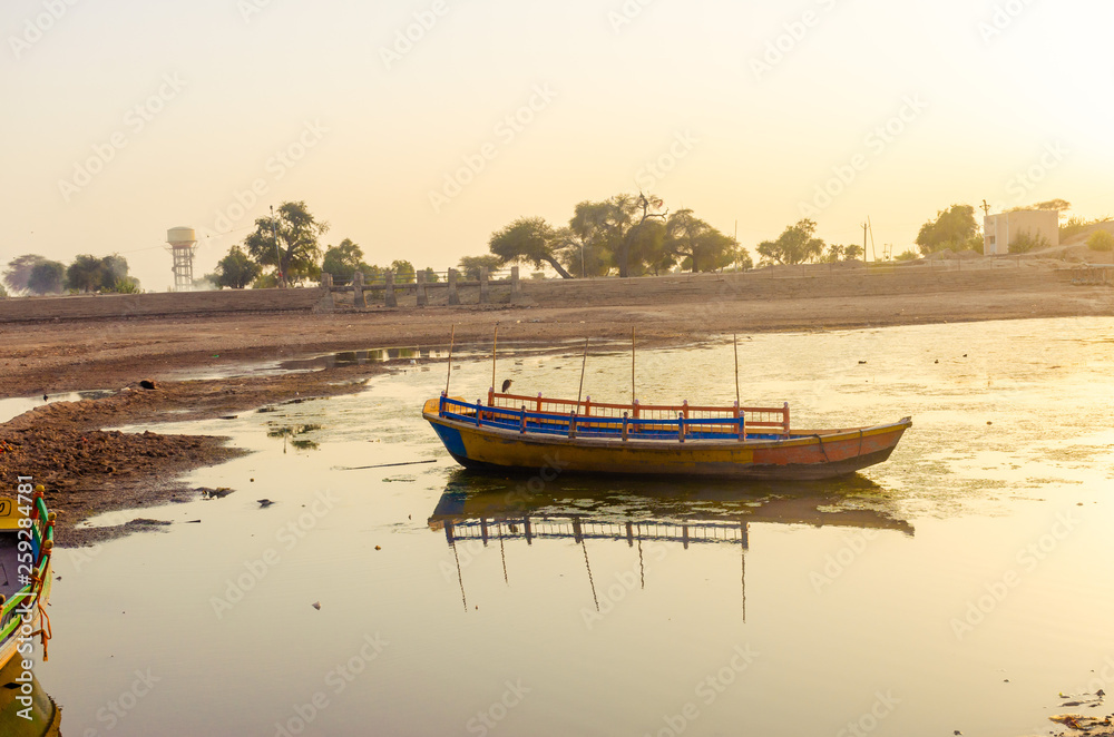 Fototapeta premium abandoned boats on the bank of dry muddy river