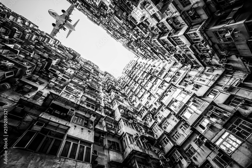 monster building in Hong Kong with airplane fly over