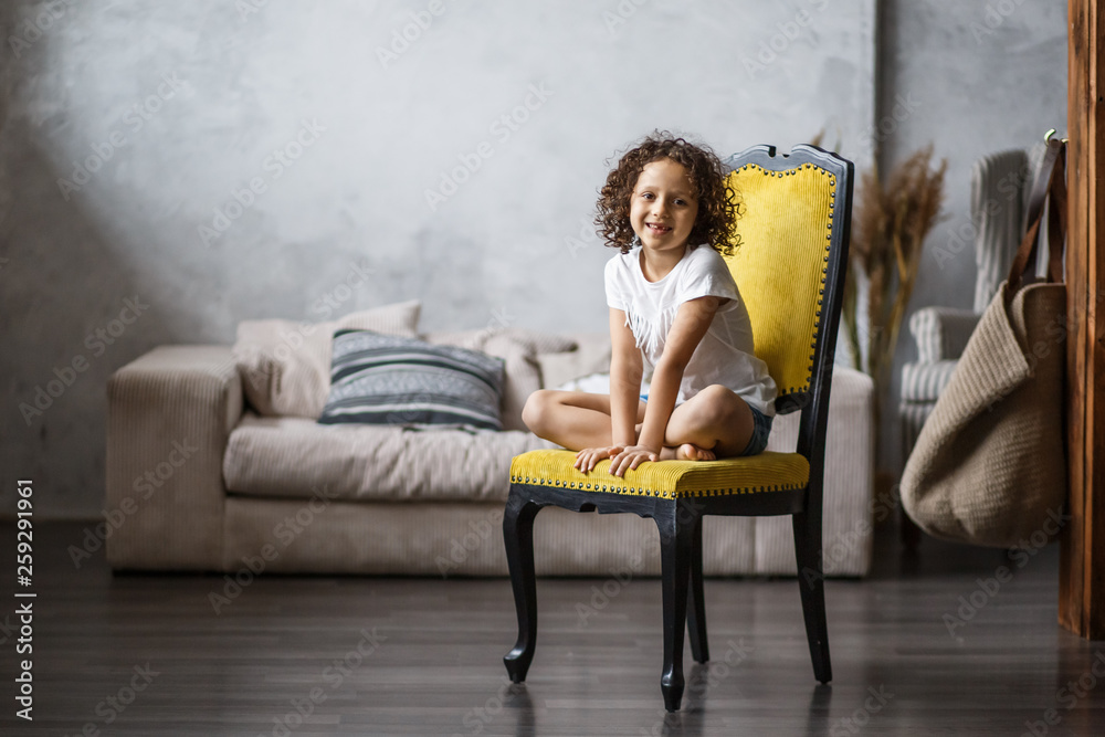 Portrait of an African American child with a smile in the room Portrait of an African American child with a smile in the room