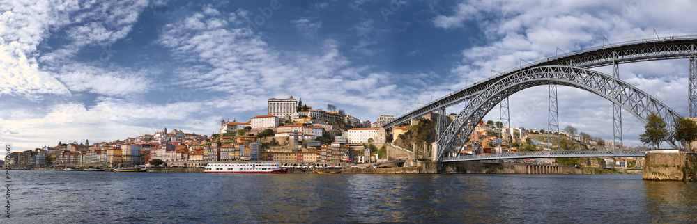 Cityscape Panorama of the historic city of Porto, the Don Luis Bridge and the Douro River in Portugal in the day in spring