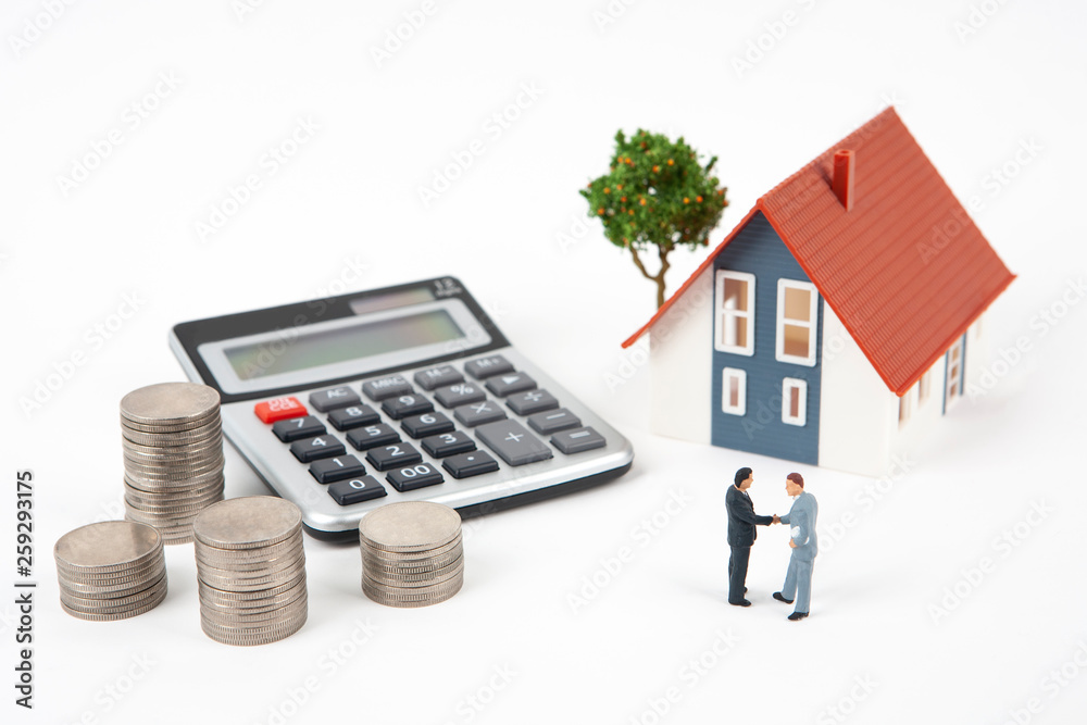 two miniature businessmen and coins with model house two miniature businessmen and coins with model house
