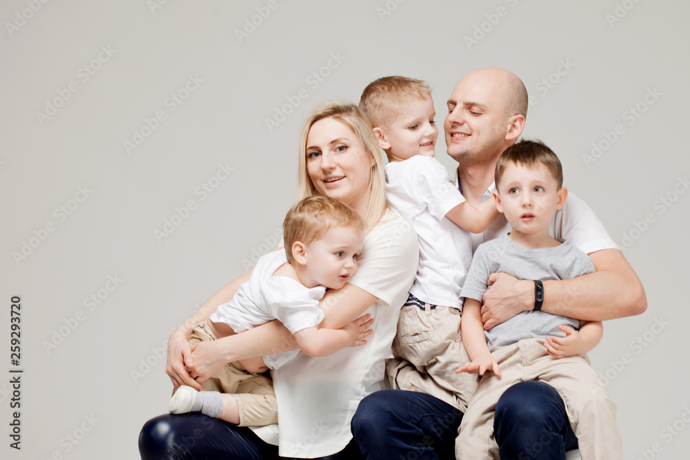 Big and cheerful family, mom dad and three sons. Happy together