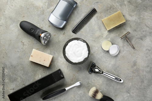 Set of male shaving accessories on grey background