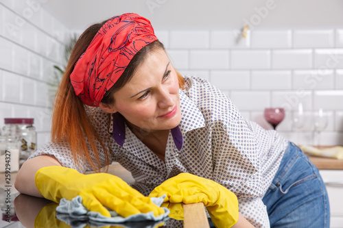 Pretty woman doing her house chores at home photo