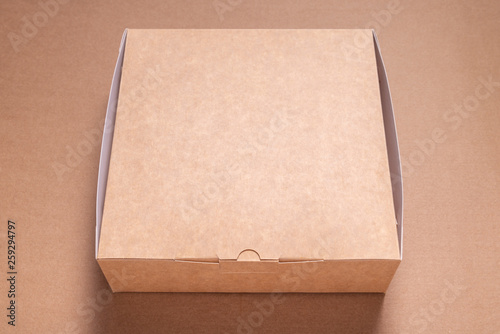 Cardboard box on brown carton background