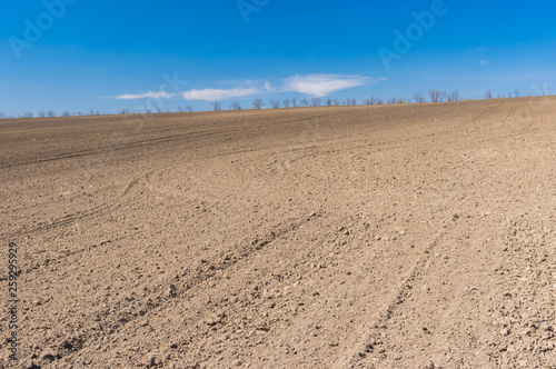 Spring landscape with soil prepared for crops sowing near Dnipro city, Ukraine