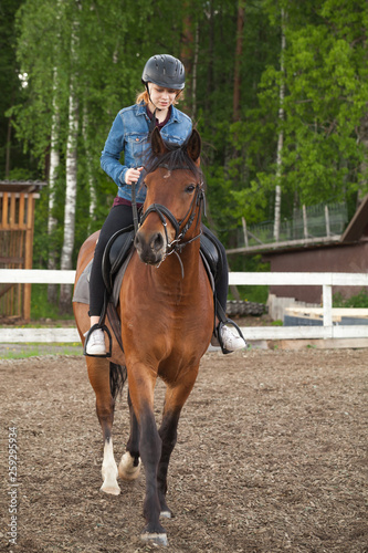 Caucasian teenage girl rides a horse