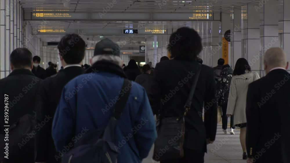 SHINJUKU, TOKYO, JAPAN - CIRCA APRIL 2019 : Scenery of RUSH HOUR at SHINJUKU. Back shot of unidentified crowd of people going back to home from work. SHINJUKU, TOKYO, JAPAN - CIRCA APRIL 2019 : Scenery of RUSH HOUR at SHINJUKU. Back shot of unidentified crowd of people going back to home from work.