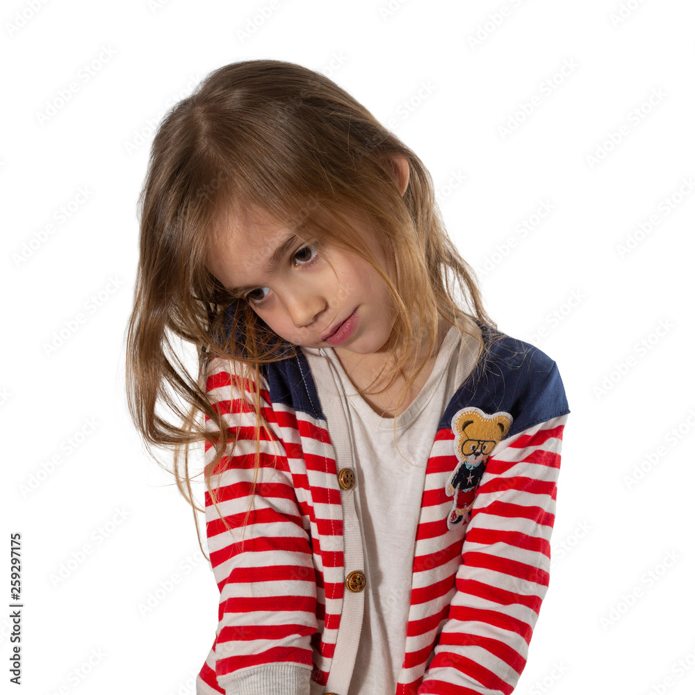 Portrait of a shy, cute girl looking down and feeling embarrassed. Photographed on a white background.