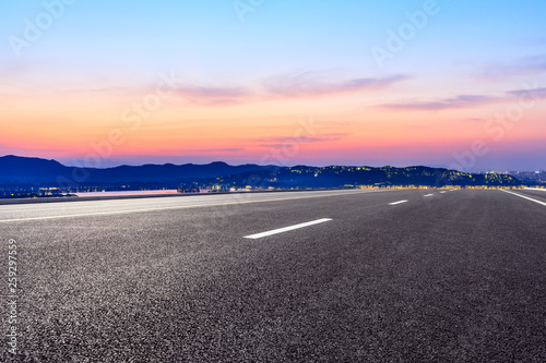 Asphalt road and beautiful mountain nature landscape at sunset