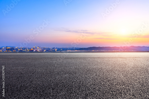 Empty asphalt road passing through the city above in Hangzhou at sunset