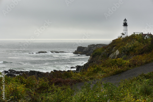 Lighthouse on the wild rocky shores of the Atlantic Ocean. USA. Maine. Portland. The oldest lighthouse of America.