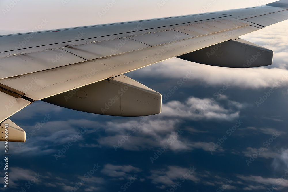 Obraz premium Sky view on clouds from the airplane window at sunset