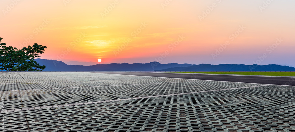 Empty square brick floor and beautiful mountain nature landscape at sunset