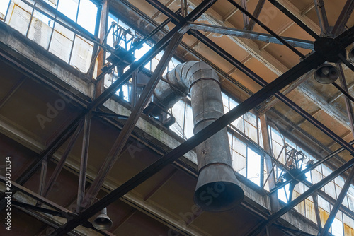 ceiling of old abandoned factories with windows and hoods