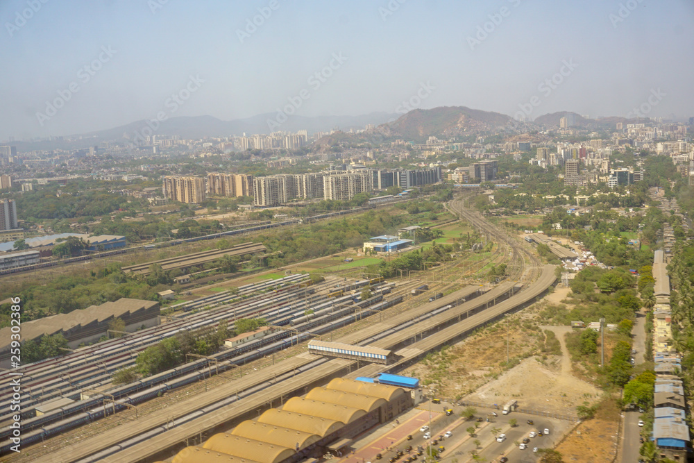 Aerial view of Kurla station in Mumbai with powai hills in the background shot from an airplane landing at Mumbai International Airport 