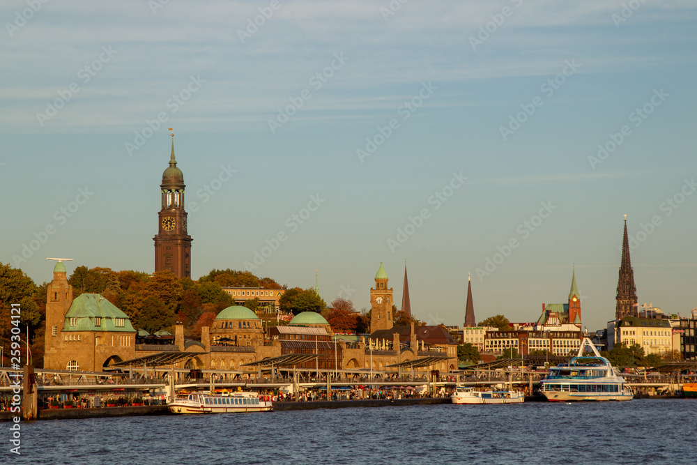 View from the Elbe river towards the St. Pauli Piers or Landungsbrücken and the St. Michael's Church in Hamburg, Germany.
