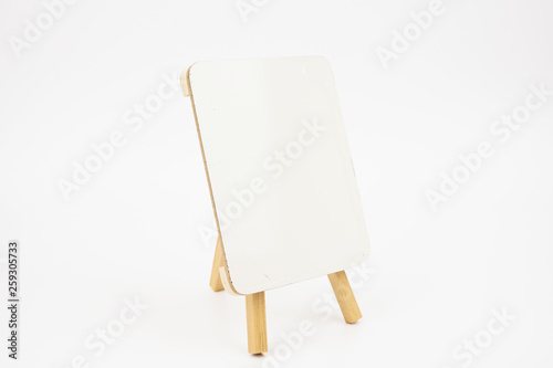 Mini wooden easel with blank white board isolated on white background. 