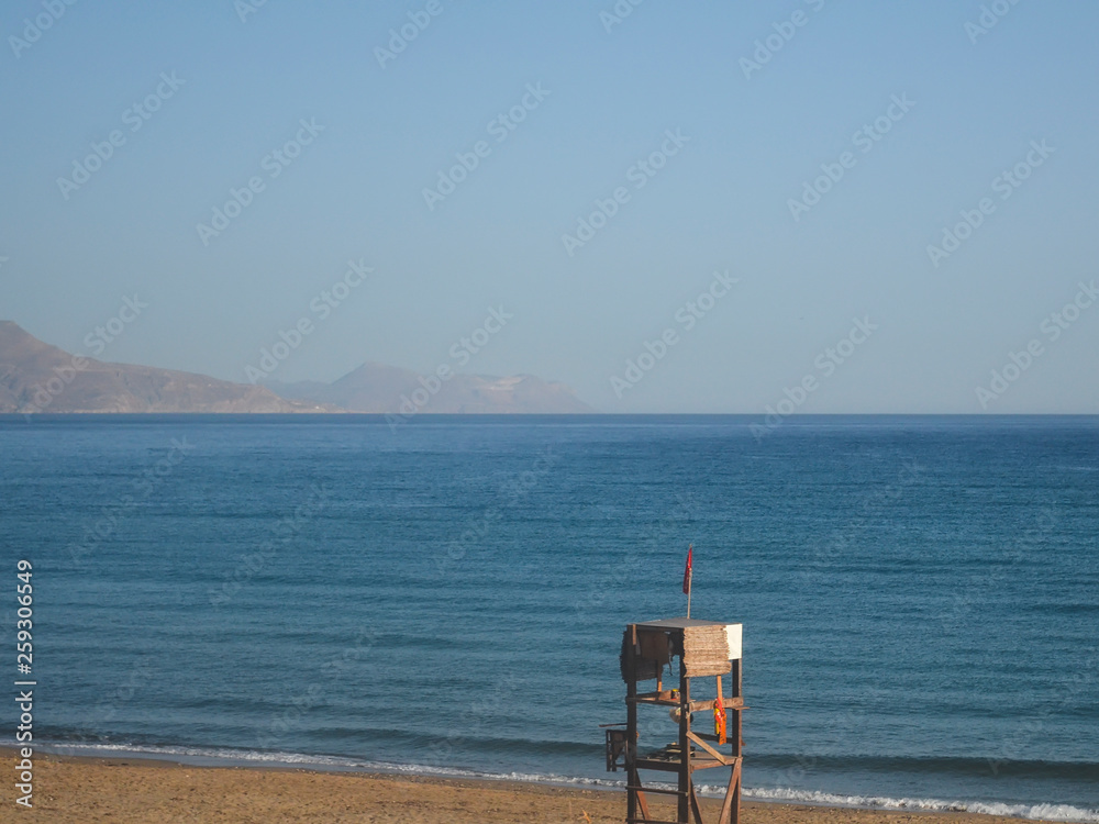 Old broken wooden lifeguard tower on an abandoned beach in the early morning