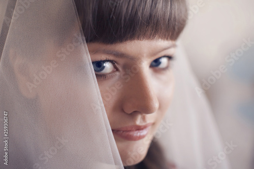 portrait of the bride in a veil. The girl is preparing for the wedding