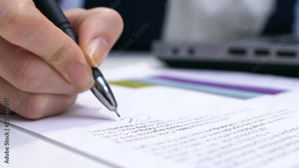 Female boss typing on laptop and signing report, approving project, authority Female boss typing on laptop and signing report, approving project, authority