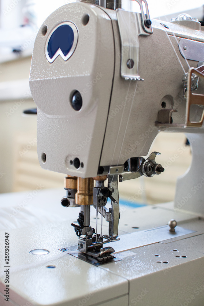 Modern sewing machine in the sewing workshop