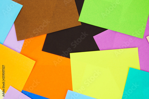 Colorful paper scatter on background. Top view, flat lay concept.