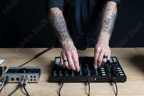 Dj man creates electronic music in the studio
