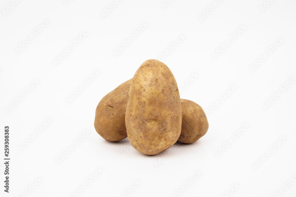 Three raw russet potatoes isolated on white background Three raw russet potatoes isolated on white background