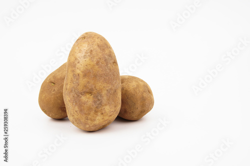 Three raw russet potatoes isolated on white background