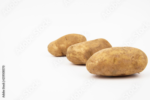 Russet potato arrange in a row isolated on white background