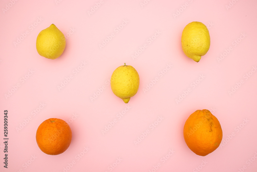 Oranges and lemons on pink background Oranges and lemons on pink background