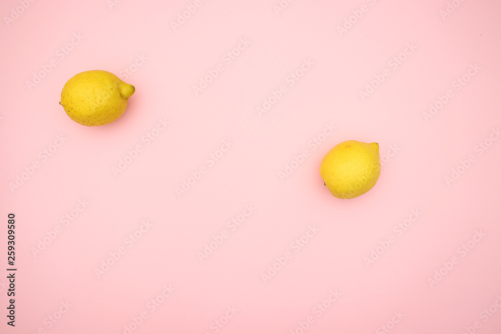 Oranges and lemons on pink background