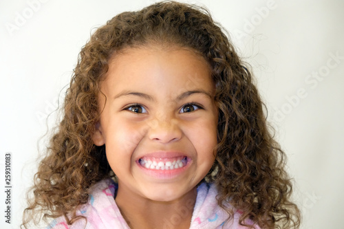 Cute girl daughter curly hair mixed race crazy smile